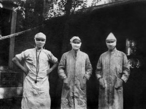 Three doctors at the Peter Bent Brigham Hospital in Boston, MA outfitted for handling the influenza epidemic of 1918.